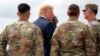 President Donald Trump greets member of the military as he arrives on Air Force One at Wheeler-Sack Army Air Field in Fort Drum, N.Y.