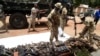 FILE - Nigerian soldiers take inventory on April 21, 2022, of small arms and light weapons recovered from bandits during an operation in north central Nigeria. 