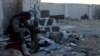 FILE - A Free Syrian Army fighter rests in an area south of Aleppo.