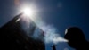 FILE - In this Jan. 18, 2012 photo, a smoker puffs on a cigarette in the central business district in Auckland, New Zealand.