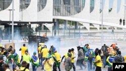 FILE - Supporters of former Brazilian President Jair Bolsonaro clash with police during a demonstration outside the Planalto Palace in Brasilia, Jan. 8, 2023.
