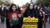 Iranian worshippers, one of them holding an anti-Israeli placard, attend a pro-Palestinian rally, before their Friday prayers in Tehran, Iran, Oct. 13, 2023.