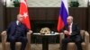FILE - In this Sept. 29, 2021, file photo, Russian President Vladimir Putin, right, and Turkish President Recep Tayyip Erdogan talk during their meeting in the Bocharov Ruchei residence in the Black Sea resort of Sochi, Russia.