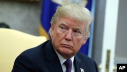 President Donald Trump in the Oval Office of the White House, Oct. 19, 2017, in Washington.