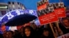 FILE - Supporters of Turkey's main opposition Republican People's Party (CHP) hold placards with pictures of four former ministers while shouting anti-government slogans during a protest in Istanbul, Turkey, Dec. 17, 2014.