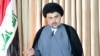 FILE - Iraqi Shi'ite cleric Moqtada al-Sadr delivers a speech in Najaf, Iraq, June 25, 2014. In what appears to be a departure from the traditional Shi'ite position, Al-Sadr has called on Syria's President Bashar al-Assad to resign.