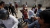 An injured garment worker is helped by his colleagues after clashes broke out during a protest in Phnom Penh, Jan. 3, 2014. 
