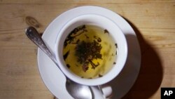 This photo shows a cup of black tea with a spoon and tea leaves in London, Monday, Aug. 29, 2022. (AP Photo/Alastair Grant)