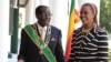 Zimbabwe President Robert Mugabe stands with his wife Grace, as they pose for a photo at State House in Harare, Oct, 28, 2014. 