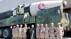 N. Korean leader Kim Jong Un and his daughter attend a photo session with the scientists, engineers and others involved in the test-fire of the new Hwasong-17 ICBM in this photo released Nov. 27, 2022 by N. Korea's KCNA via Reuters. 