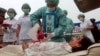 Members of Falun Dafa practitioners simulate organ harvesting in a mock Chinese labor camp in protest against China's suspected abuse and killing of Falun Gong members, Sunday, April 23, 2006, in front of the Presidential Office in Taipei, Taiwan. (AP Photo/Chiang Ying-Ying)