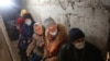 FILE - Residents of Sievierodonetsk, Lugansk Oblast, wait hidden in their basement during the heavy shelling by Russian forces and Russia-backed separatists, Feb. 28, 2022.