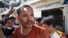 Meach Sovannara, a jailed CNRP's head of Information Department escorted by police in front of the Court of Appeals on Tuesday, August 23, 2016. (Photo: Leng Len/VOA Khmer)