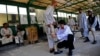 FILE - A medic adjusts a prosthetic leg at the International Committee of the Red Cross orthopedic hospital in Kabul, Afghanistan, Saturday, July 17, 2010.