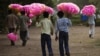 Vendors hold bags of cotton candy for sale as they look for customers in New Delhi on June 28, 2012. India's food inflation rose to 10.66 percent in May from 10.18 percent in April, latest figures show. 