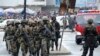 FILE - Liberian army soldiers walk on the Monrovia bridge during a training exercise in Monrovia, June 24, 2016.