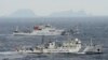 An aerial photo shows Chinese marine surveillance ships Haijian No. 49 (front) and Haijian No.50 cruising in the East China Sea, as the islands known as Senkaku isles in Japan and Diaoyu islands, April 23, 2013.