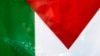 FILE - An Islamist protester shouts slogans from behind a Palestinian flag during a demonstration in front of Fatih Mosque in Istanbul.