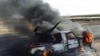 A pro-Moammar Gadhafi anti-aircraft machine gun is burned by Libyan rebels during a battle, in the town of Brega, east of Libya, March 2, 2011 