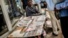 A Street vendor sells newpapers with elections headlines at a central street, Oct. 16, 2014 in Maputo. 