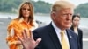 FILE - U.S. President Donald Trump, right, and First Lady Melania Trump arrive at the Japanese destroyer JS Kaga, in Yokosuka, south of Tokyo.