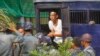 A student protester exits a prison vehicle, as he is sent to a court in Letpadan, Myanmar, March 11, 2015. 