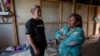 FILE - Francisca Ramirez, right, talks with Deputy High Commissioner for the U.N. Refugee Agency, Kelly Clements, in a community of Nicaraguan refugees, in Upala, Costa Rica, Feb. 8, 2020.