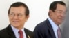 Cambodia's Prime Minister Hun Sen, right, walks with opposition Cambodia Rescue Party Deputy President Kem Sokha, left, during a break at National Assembly in Phnom Penh, Cambodia, Wednesday, Dec. 7, 2016. 