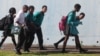 FILE - Students leave school at the end of the day in a suburb of Johannesburg, South Africa.