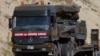 FILE - A Turkish military truck is seen transporting a mobile missile launcher to the Syrian border, near Kilis, Turkey.