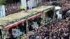 Mourners gather around a truck carrying coffins of Iranian President Ebrahim Raisi and his companions who were killed in their helicopter crash in mountainous region of the country's northwest, during a funeral ceremony at the city of Tabriz, May 21, 2024. (Fars News Agency)