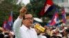 FILE - Sam Rainsy (C), leader of the opposition Cambodia National Rescue Party is seen speaking at a protest in central Phnom Penh, December 17, 2013.