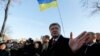 FILE - Ukraine's President Petro Poroshenko speaks with people after a wreath laying ceremony at the monument to the fallen Heroes of the "Heavenly Sotnya (Hundred)," in Kyiv, Ukraine, Nov. 21, 2014.