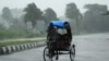 Rickshaw driver plows through heavy rain in Berhampur, about 180 kilometres south of Bhubaneswar, Oct. 12, 2013.