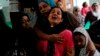 Tin Tin Kyaw (2nd R) cries near the body of her husband Soe Min, a 51-year-old man who was killed in a recent riot, at a mosque in Mandalay July 3, 2014.