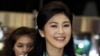 FILE - Former Thai Prime Minister Yingluck Shinawatra smiles as she arrives at Bangkok's Suvarnabhumi Airport, July 23, 2014.