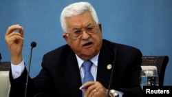 FILE - Palestinian President Mahmoud Abbas gestures as he speaks to the foreign media in Ramallah, in the Israel-occupied West Bank, June 23, 2019. 