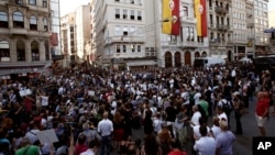 Media workers take part in a rally as police with water cannon trucks block them on Istiklal Street in Istanbul's main shopping strip, July 12, 2013. 