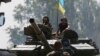 Ukrainian soldiers look out from a tank at a position some 60 km from the eastern Ukrainian city of Donetsk, July 10, 2014.