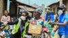 Volunteers gesture as they direct an elderly woman at an ongoing distribution of food parcels, during a lockdown by the authories in efforts to slow the spread of the coronavirus disease (COVID-19), in Lagos, April 9, 2020.