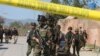 Pakistani soldiers cordon off the area of suicide bombing in Charsadda, Pakistan, Feb. 21, 2017. Police say three suicide bombers attacked a courthouse in northwestern Pakistan