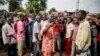 Joseph Bendounga (C), a local opposition leader, speaks to a crowd of people angered by an attack on a church in central Bangui, May 29, 2014.