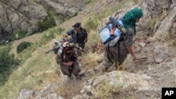 FILE - Rebels of the Kurdistan Workers Party (PKK) are seen in Turkey near the border with Iraq, May 2013.