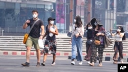 FILE - Tourists wear masks in Chiang Mai province, Thailand, April 2, 2019. The air hanging over Thailand's far north has become so polluted, the prime minister went Tuesday to see in person what's been called a severe health crisis.