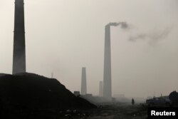 A general view of brick factories as smoke rises from the stacks in the town of Nahrawan in Baghdad, Iraq, June 3, 2019.