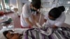 FILE - A Hepatitis-B patient Bharat Prajapati, 21, receives medical treatment at an isolation ward of the Civil hospital in Ahmadabad, India.