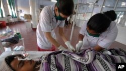 FILE - A Hepatitis-B patient Bharat Prajapati, 21, receives medical treatment at an isolation ward of the Civil hospital in Ahmadabad, India.