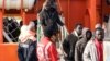 Migrants disembark from a tug boat after being rescued in the harbor of Lampedusa, Italy, Feb. 16, 2015. 