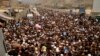 FILE - Afghan nationals prepare to cross the Torkham border post in Pakistan en route to Afghanistan, March 7, 2017. 