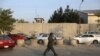 FILE - An Afghan security official patrols after an attack on the American University of Afghanistan in Kabul, Afghanistan, Aug. 25, 2016.